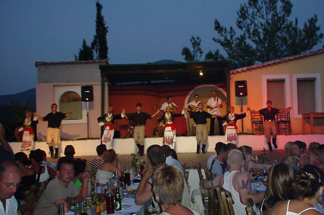 Guests enjoying a Cretan feast with live cultural entertainment